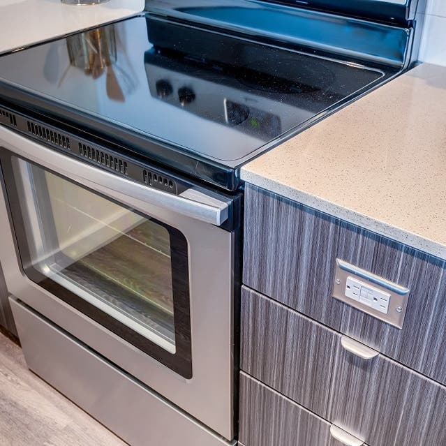 Osprey Apartments - close up of stainless steel appliances and white countertop