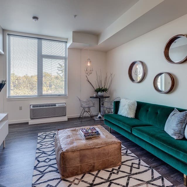 Osprey Apartments - open concept living room with hardwood-style flooring