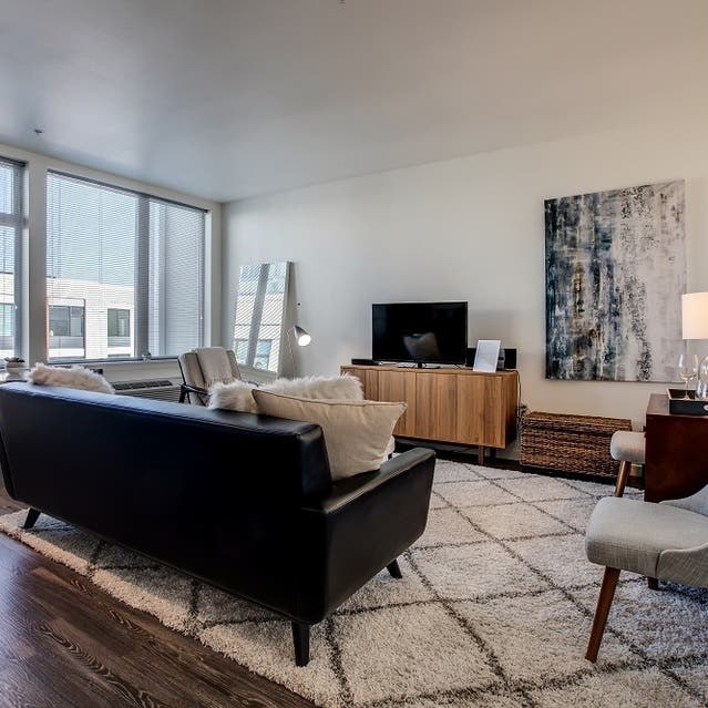Osprey Apartments - open concept living room with hardwood-style flooring