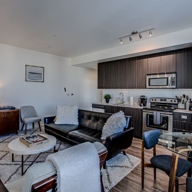 Osprey Apartments - open concept living room with hardwood-style flooring
