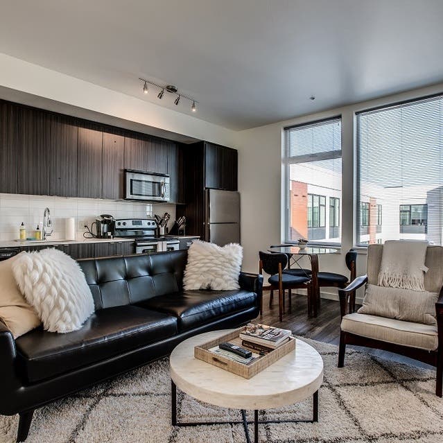 Osprey Apartments - open concept living room with hardwood-style flooring