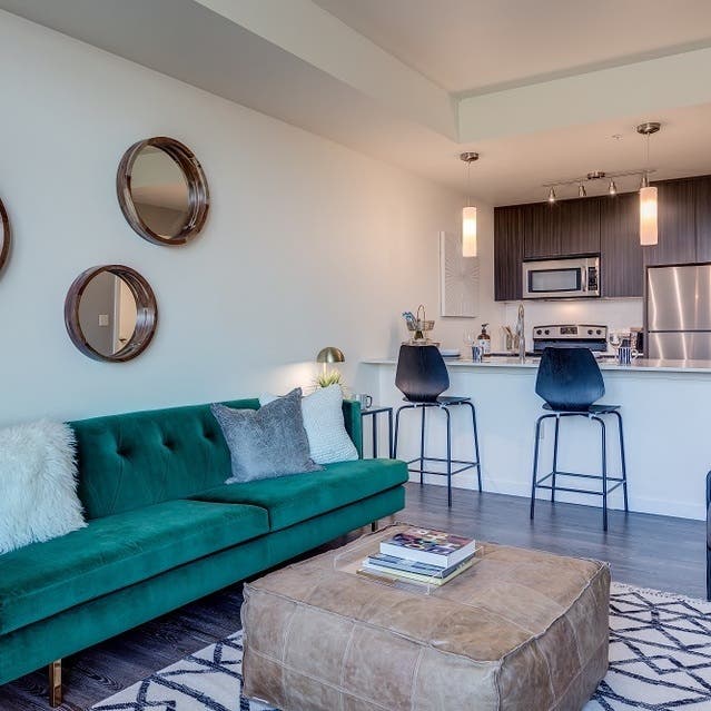 Osprey Apartments - open concept living room with hardwood-style flooring