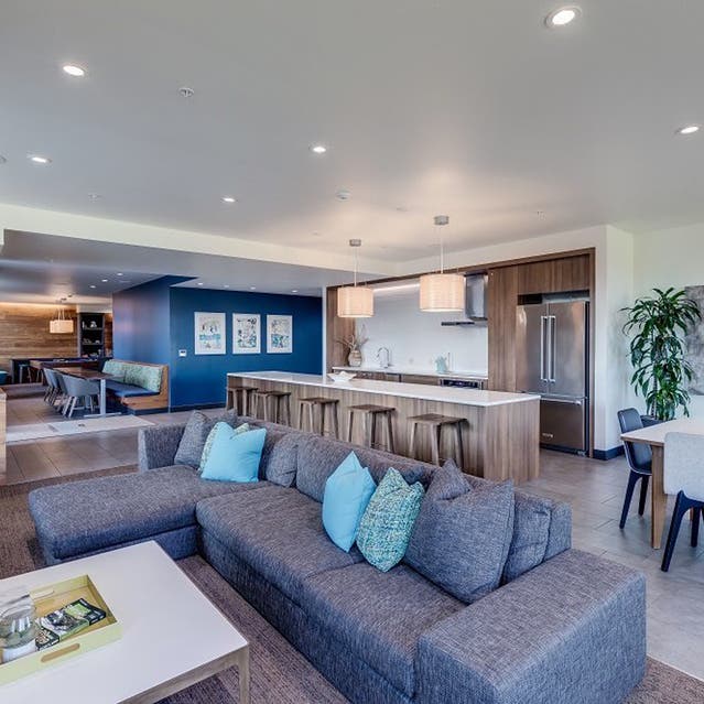 Osprey Apartments - clubhouse with couch and catering kitchen