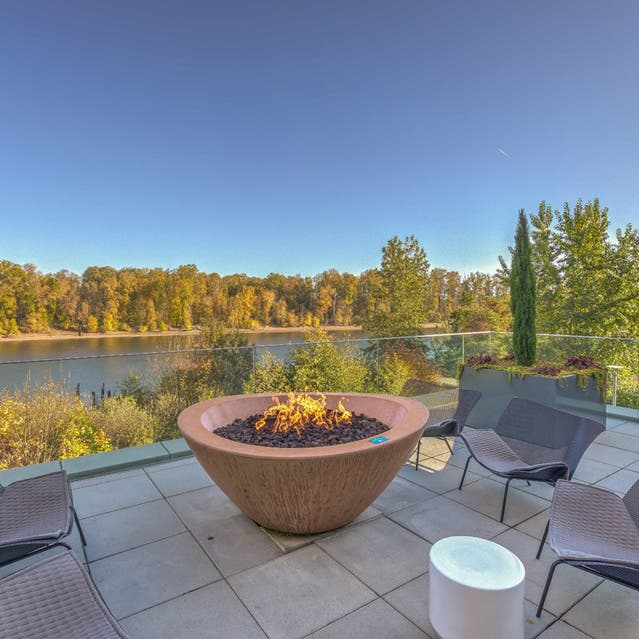 Osprey Apartments - river terrace with outdoor seating and fire pit